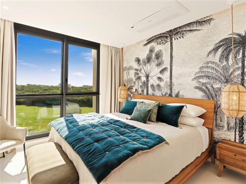 a bedroom with a large bed and a large window at Fourteen at Mullet Bay in Cupecoy