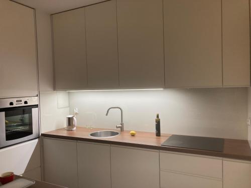 a kitchen with a sink and a counter top at Smile Apartment in Osielsko