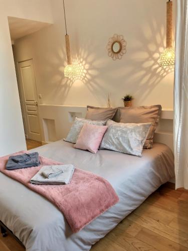 une chambre avec un lit avec deux serviettes dessus dans l'établissement Le Divio - Homillesime, à Dijon