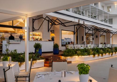 um restaurante com mesas e cadeiras e um bar em Furore Grand Hotel em Furore