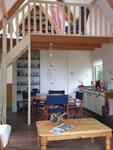 a kitchen and dining room with a loft at Vakantiewoning "De Kei" in Warns
