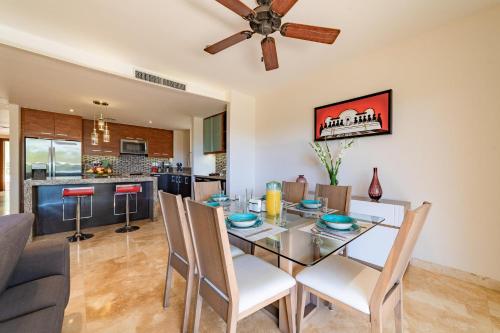 a dining room with a table with chairs and a ceiling fan at 2095 - Cosmo 8A1 in Tangolunda