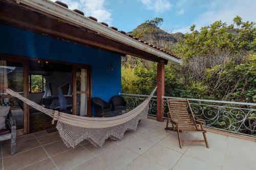 a hammock on a porch of a house at Pousada do Capão Chapada Diamantina in Vale do Capao