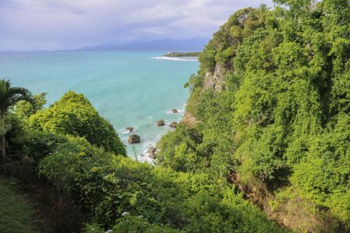 a view of the ocean from a mountain at La vue du phare - Appartement neuf avec vue imprenable et acces crique in Le Gosier