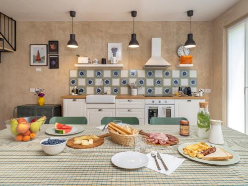 a kitchen with a table with food on it at Green Lodge in Cressa