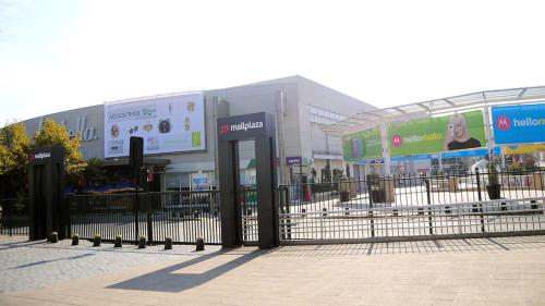 a fence in front of a building with billboards at Casa en Santiago equipada in Santiago