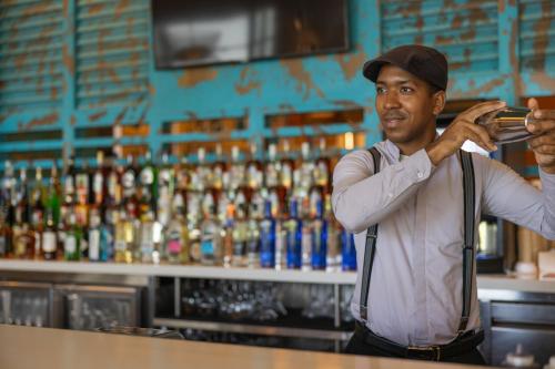a man standing at a counter at a bar at Hyatt Zilara Cap Cana - Adults Only in Punta Cana