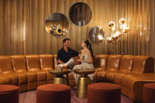 a man and a woman sitting in a waiting room at Hyatt Zilara Cap Cana - Adults Only in Punta Cana
