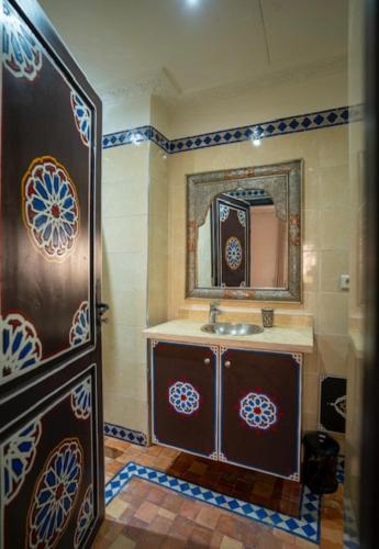 a bathroom with a sink and a mirror at Villa Leila Farmhouse in Marrakech
