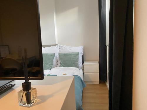 a bedroom with a bed and a desk with a mirror at LUX Apartments in Mörfelden-Walldorf