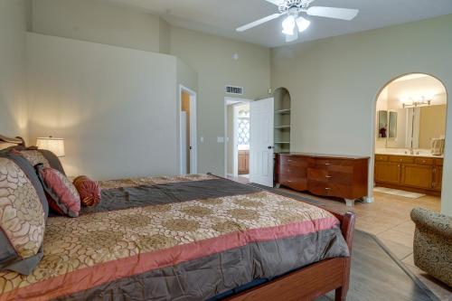 a bedroom with a bed and a dresser and a bathroom at Pet-Friendly Peoria Home Near State Farm Stadium! in Peoria