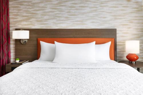 a bedroom with a large bed with white pillows at Home2 Suites By Hilton Lake Mary Orlando in Lake Mary
