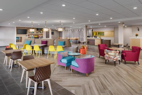 a waiting room with colorful chairs and tables at Home2 Suites By Hilton Lake Mary Orlando in Lake Mary