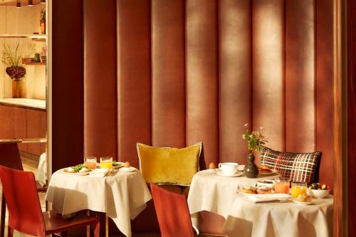 a restaurant with two tables with food on them at Villa-des-Prés in Paris