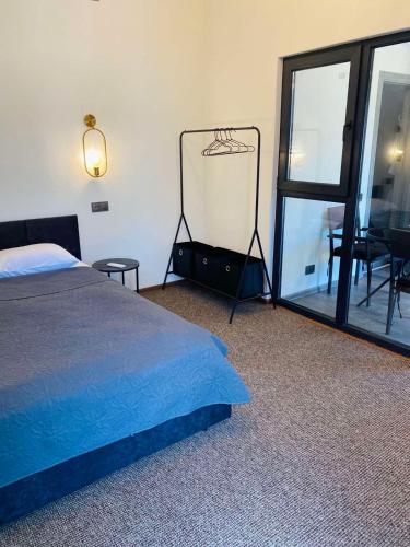 a bedroom with a bed and a mirror and a table at Райский Дворик in Pogreby