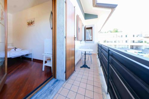 a hallway with a table and a sink in a room at Chiarelli House in Udine