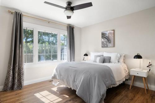 a white bedroom with a bed and a window at Fields Inn Executive Townhouse in Kingston