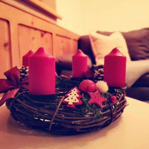 a birthday cake with pink candles on a table at Haus Marieus in Umhausen
