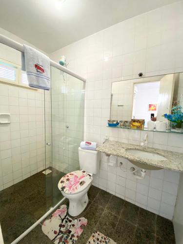 a bathroom with a toilet and a sink and a mirror at Pousada & Food 3 Abelhas in Cumbuco