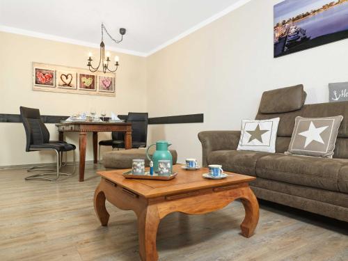 a living room with a couch and a coffee table at Residenz am Yachthafen Schiffskieker in Kirchdorf