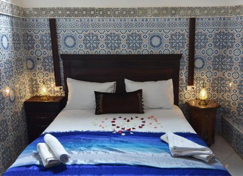 a bedroom with a bed with flowers on it at Dar Aya Fes in Fès