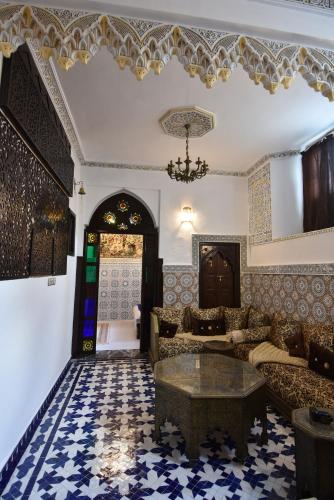 a living room with a couch and a table at Dar Aya Fes in Fès
