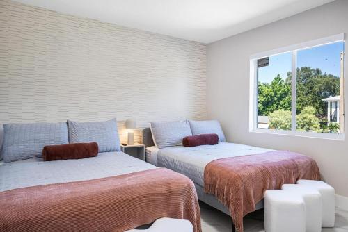 a bedroom with two beds and a window at 4 Bedroom Holiday Retreat BBQ Marketplace in Miami
