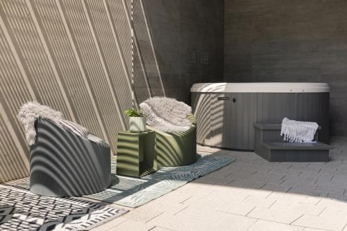 a rendering of a patio with two chairs and a heater at GOING TRIPLE A apartments WEST in Going