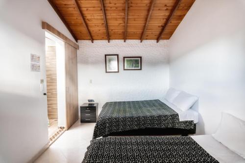 Postel nebo postele na pokoji v ubytování Fami Hotel Vive Jardin