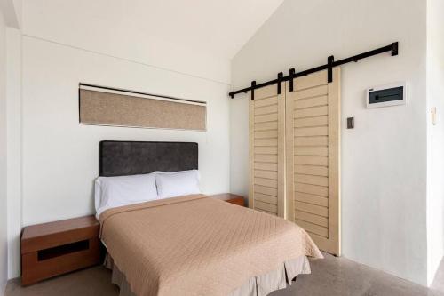 ein Schlafzimmer mit einem Bett und einer Schiebetür in der Unterkunft 3-Bedroom Villa with Pool in Santa Cruz