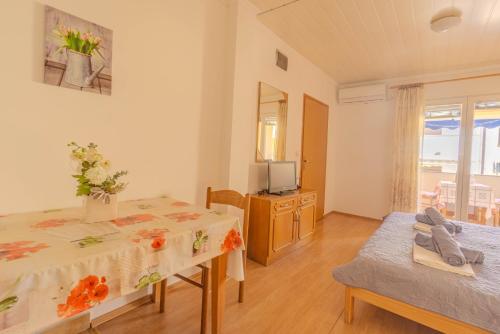 a living room with two tables and a television at Veli Zal in Zubovići