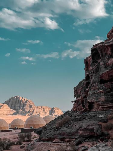 a view of the desert with mountains in the background at Lulua luxury camp in Wadi Rum