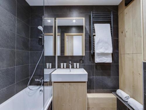 une salle de bain avec un lavabo et une baignoire dans l'établissement Charmant 3 Pièces avec Parking, Wifi, et Proche Remontées à Val d'Isère - FR-1-567-90, à Val dʼIsère