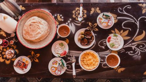 a table with plates of food on a table at Stamps Siwa Oasis in Siwa