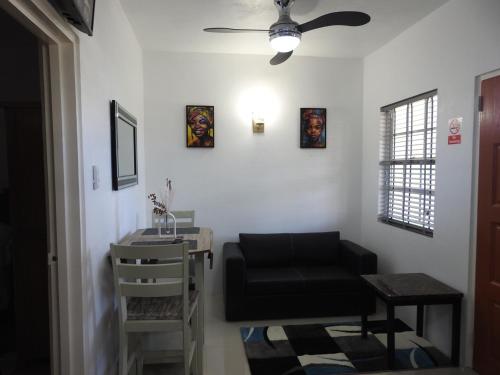 a living room with a black chair and a table at Belview Apartments in Belmont