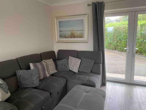 a living room with a couch and a window at Cois Locha in Glenbeigh