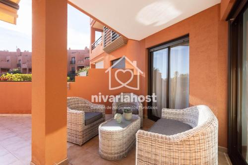 een pension met een balkon met rieten meubels bij Sunset View La Tejita, by Nivariahost in Granadilla de Abona