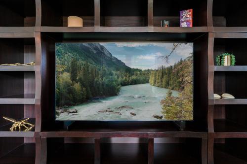 a flat screen tv sitting on a shelf with a river at The Estate at Mt Dora in Mount Dora