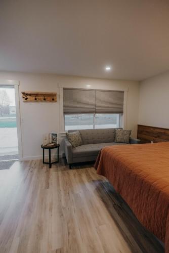 a living room with a bed and a couch at Bingham Motor Inn in Bingham