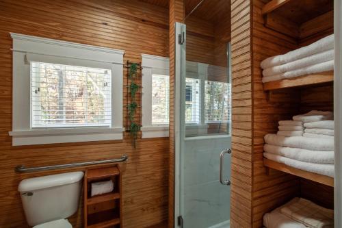a bathroom with a shower and a toilet and towels at Airplane Filling Station -Unique Stay in Knoxville in Knoxville