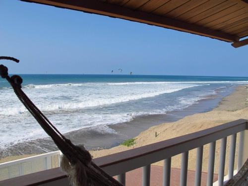 a view of the beach from a balcony at Los Sonidos de las Olas in Santa Marianita