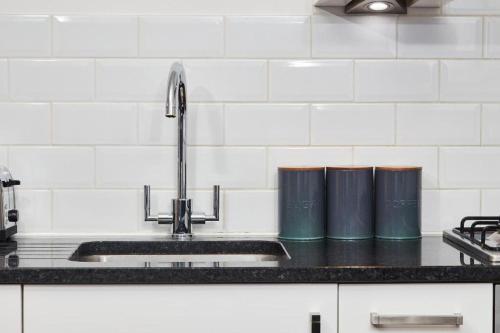 a kitchen sink with a faucet and a counter at The Hepburn Suite - In Central Bath in Bath