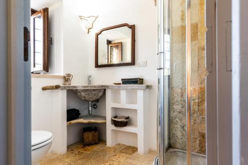 a bathroom with a sink and a shower at Sopra i Sassi - Villa & Trulli in Ostuni