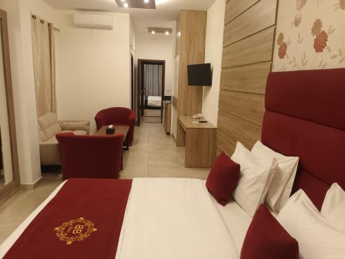a hotel room with a bed and a living room at Batroun boutique suites in Batroûn