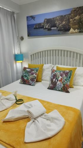 a bed with white towels on top of it at Ferhouse Dreams in Nazaré