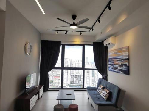 a living room with a couch and a large window at Seaview Infinity Pool #6pax #2bedroom #2bathroom in Jelutong