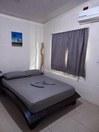 - un lit dans une chambre avec fenêtre dans l'établissement Nick's Place Room #1, à Pavones