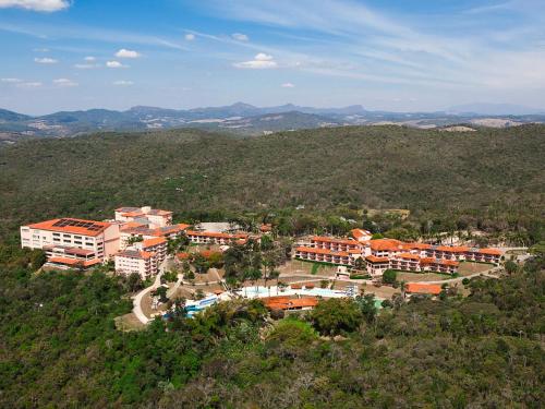 an aerial view of a town with buildings and trees at Tauá Hotel & Convention Caeté in Caeté