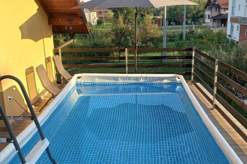 - une piscine avec un parasol sur le balcon dans l'établissement Kuća za odmor- Milošev Konak Banja Luka, 