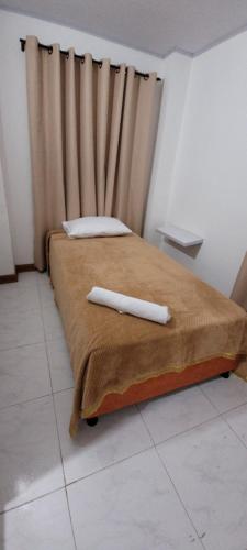 a bed with two white pillows on top of it at Andy's House in San Andrés